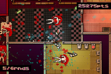 A top-town pixelated screenshot of the player wearing a rooster mask aiming a shotgun at a door, preparing to shoot at the mobsters breaking through. The player's score is visible in the top-right of the image.