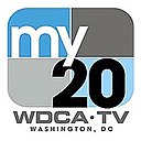A rounded rectangle divided into blue and gray parts with the word "my" in white and a black "20" in the lower right. Underneath is the text "W D C A TV Washington, DC".
