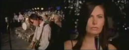A screenshot of the music video to Ivy's 2000 single "Lucy Doesn't Love You", showing lead singer Dominique Durand side-by-side with scenes of the other members to Ivy performing.