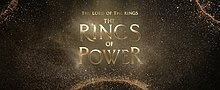 The series' title, "The Lord of the Rings: The Rings of Power", in glowing gold letters in front of sparkling dust.
