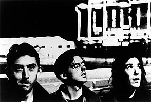 High-contrast black-and-white photo of the three foremembers of the band.