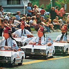 Shriners drive tiny cars in a parade