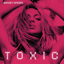 Image of a blonde woman with a layer of light brown. She has her arms extended over her head. On the upper left side of the image, the words "Britney Spears" are written in white letters. Underneath, "Toxic" is written in big white letters.