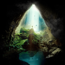 A ray of light is vertically shining down on a green hill, with a silhouette of a person standing on top and birds flying around. The visual is seen in the perspective of a rocky cave entrance covering the left and right sides of the cover in the shape of a triangle, and a pond located underneath the entrance