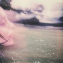 Cover art for Guitar Songs: a washed-out photo of Billie Eilish on a field of grass. Written in thin white is the EP's name and its tracklist.