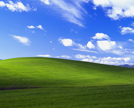 Rolling green hills and a blue sky with stratocumulus and cirrus clouds