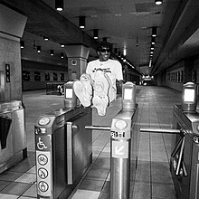 A man jumps over a turnstile.