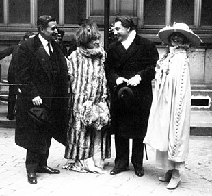 outdoor wedding photograph of middle-aged man (Feydeau), middle-aged woman (Bernhardt) and young couple, all laughing or smiling