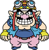 An overweight character with pointy ears, a pink nose, thick eyebrows, muscular arms and a wavy moustache. He wears a navy blue shirt with a light blue jacket, pink pants with a red belt, blue shoes, and yellow biker gloves with a blue W. On his head, a yellow biker helmet with a blue W, goggles, and a red strap.