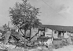 A simply built shack, largely reduced to rubble