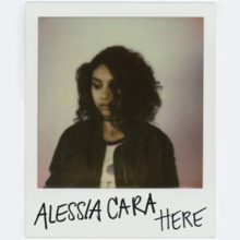 A polaroid of Alessia Cara. The artist's name and song title are written in black on the polaroid.