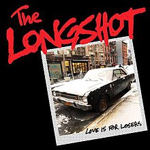 The Cover shows a Black Car with snow on the other part of that car. On top of the Picture, says LONGSHOT In Red.