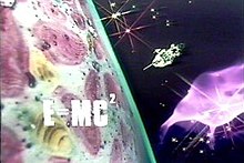 The image shows a futuristic spaceship approaching a brightly-coloured planet, with a nebula and stars in the background and the formula "E=MC2" superimposed in bold upper-case letters over the planet.