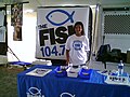 An unidentified employee with the FISH at a booth at the Georgia International Horse Park during the concert.