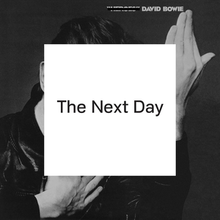 The album cover features a black and white photograph of Bowie's face with his hands held up. A white box obscures his face and much of the photograph with a text in the center reading "The Next Day". On top, the text reading "Heroes" is crossed out.