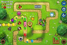 Screenshot of a game of Bloons TD 5 Mobile. The game is currently played on Round 34 with a number of monkey and machine towers, many of which have low-level upgrades.