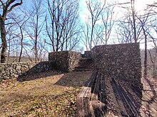 A large stone structure in a wooded area