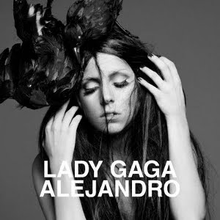 Greyscale image of Gaga with unkempt black hair which falls around her face. A crow sits on top of her head.