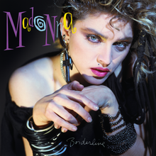 Madonna clasping hands and facing toward camera shoot. Bunch of plastic ring bracelets on right wrist; metal bead bracelet on left wrist. She also wears huge crucifix earrings. The background is dark. The font of "Madonna" is unconventional and unique, and located at upper left; size is very big. "Borderline" is handwritten and located at bottom center.
