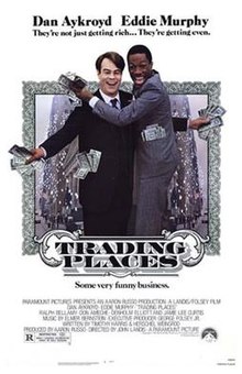 Theatrical release poster showing Dan Aykroyd and Eddie Murphy as their respective characters, with dollar bills in their hands and pockets.