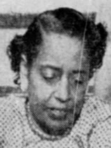 A Black woman with hair in a short set style, looking downward