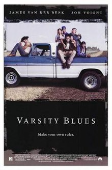 A blue and white pick-up truck. One man wearing a cowboy hat sits on the hood of the truck, a group of people sit together at the back