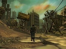 A screenshot from the game Fallout Online. In the center of the image is a man standing with his back to the camera. He is standing next to a destroyed road. Toppled telephone poles and a broken billboard are in the background.