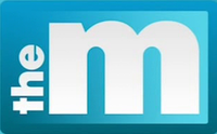 A light blue rectangle appears. Within it, white text appearing vertically and reading upward features "the" rendered in bold lower-case. Next to it, a thicker letter "m" in lower-case fills the remainder of the rectangle, thus reading to the eye as "the m".