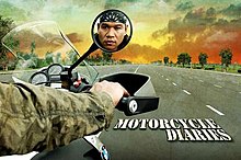 An image of Jay Taruc riding a motorcycle. Taruc's face is visible on the wing mirror. The show title is displayed on the lower right side of the image.