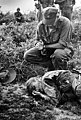 Huet's poignant photograph of colleague Dickey Chapelle receiving last rites after being fatally wounded by a booby trap in Vietnam.