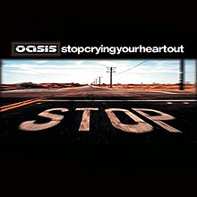 Picture of a desertic road. In the pavement the word "Stop" is painted in capital white letters. Above it, Oasis's stylised logo and "Stop Crying Your Heart Out", written in lowercase white letters and without spaces, appear.