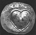 Ancient silver coin from Cyrene, Libya depicting the heart-shaped 'seed' (actually fruit) of silphium.