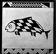 Photo of square side of pottery showing fish with skewed checkered pattern on its skin. Zig-zag lines represent waves at the top and bottom.