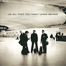 U2 standing in a plane terminal, photographed in a black-and-white sepia tone