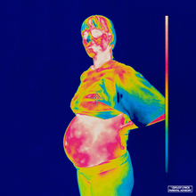 A picture of a pregnant woman in thermal cam with a blue background and a billiard cue.