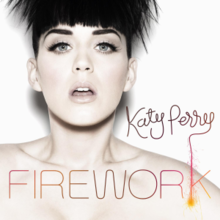 A woman with short hair in front of a white background with "Katy Perry" written in brown and "FIREWORK" in orange text