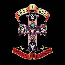 skulls resembling the members of Guns N’ Roses on an ornate cross on a black background, with the band name and album title written sideways on the left and right, respectively.