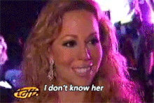 Mariah Carey saying the phrase "I don't know her" while smiling and shaking her head.