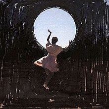 A woman dances against a black background while holding a circle of the sky.