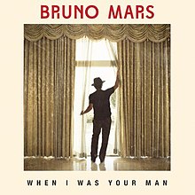 Bruno Mars standing with his back turned opening a drapery, the words "When I Was Your Man" with capital font can be seen on the bottom of the picture, while the words "Bruno Mars" in red capital font are on the top of the image.