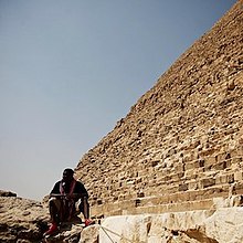 Jay Electronica sits at the foot of a pyramid