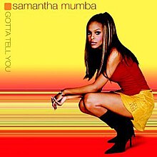 Mumba squatting on the right side of the cover, which the top half is yellow and the bottom half red