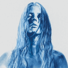 Image of a woman with wet hair and negative blue hue effect.