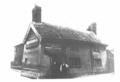The predecessor to today's structure, named the Thatched House Tavern, pictured around 1880. Landlord Nicholas Charnock is likely the person on the right