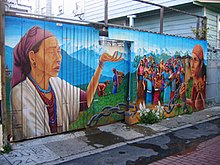 A Precita Eyes' mural on a garage door and fence in Balmy Alley