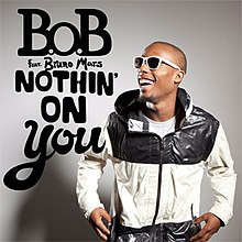 A picture of B.o.B standing up on the left of the image while laughing, with the words "B.o.B feat. Bruno Mars Nothin' on You" with capital font on the right of B.o.B