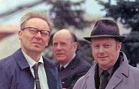 three middle aged white men in informal snapshot, outdoor setting