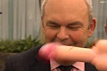 Face of Steven Joyce partly obscured by a large rubber penis