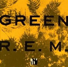 A golden yellow background with dark green impressions of leaves on it and the words "GREEN" and "R.E.M." written on top in black