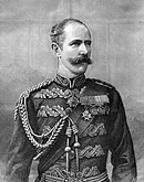 Engraving of Major General Sir Herbert Stewart with handlebar moustache, wearing uniform jacket decorated with applique stylised foliage with sash, braided lanyard, and medals